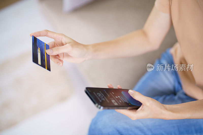 Asian woman with smart phone for online shopping.  Hand holding mobile phone with Payment on credit card online shopping electronic wallet Payment Shopping by phone connected card concept